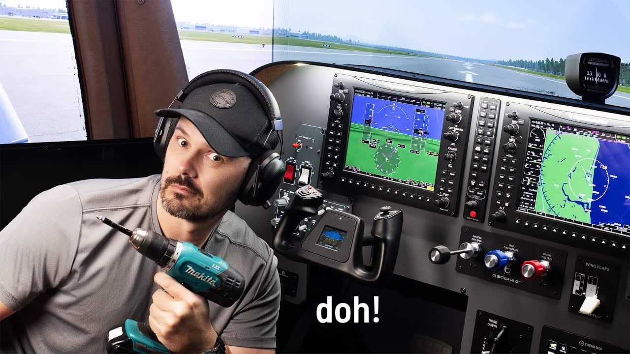Man holding a drill in front of a flight simulator