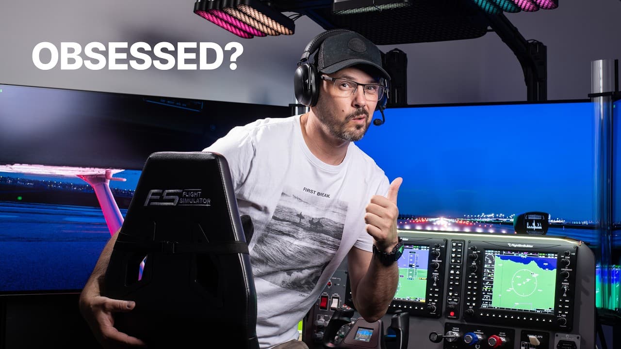 Man standing in front of a flight simulator pointing
